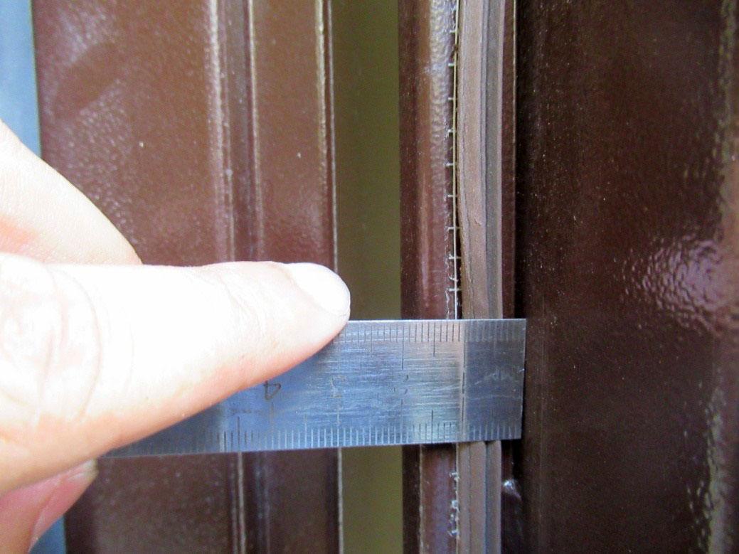 Экспертиза входной металлической двери с замером зазора между коробкой и створкой